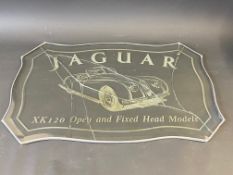 A Jaguar XK120 pictorial glass advertising sign in a lead frame, damaged, 28 1/2 x 19 1/2".
