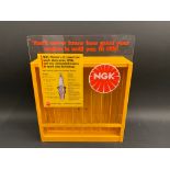 An NGK plug display holder, 11" w x 14" h x 4 1/2" d.