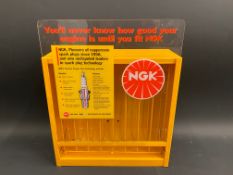 An NGK plug display holder, 11" w x 14" h x 4 1/2" d.