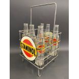 A rare Staminol nine division oil bottle crate with two circular tin advertising signs attached