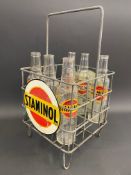 A rare Staminol nine division oil bottle crate with two circular tin advertising signs attached