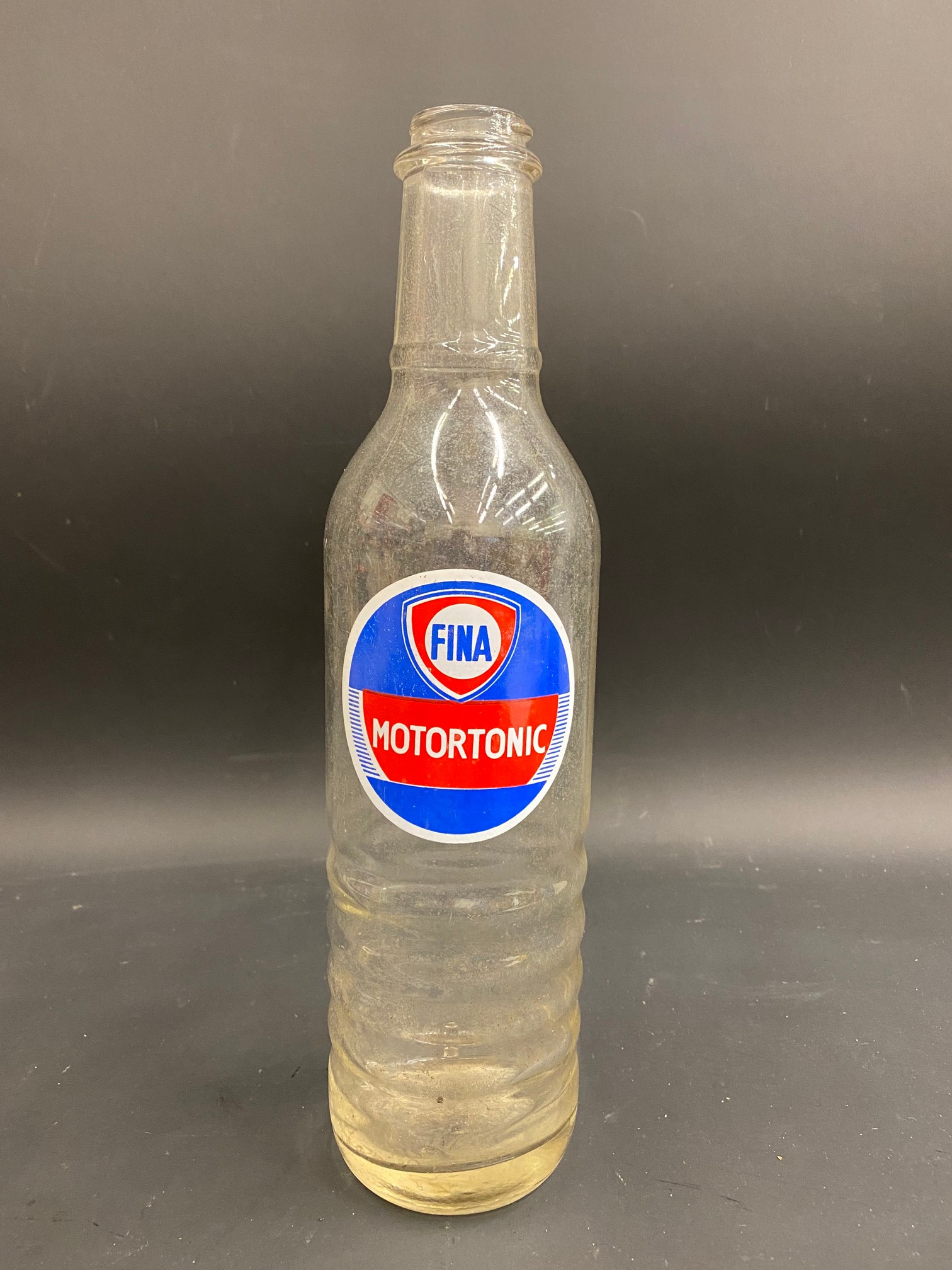 A Fina Motortonic quart glass oil bottle.