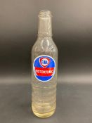 A Fina Motortonic quart glass oil bottle.