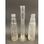 A Shell measuring tube and two glass oil bottles.