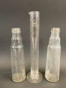 A Shell measuring tube and two glass oil bottles.