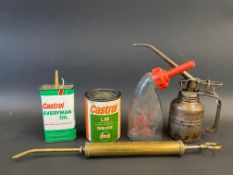 A slender brass oiler, a Castrol grease tin, a Lucas battery filler and two oil cans.