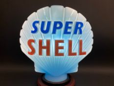 A blue Super Shell glass petrol pump globe by Hailware, in good condition, dated December 1973,