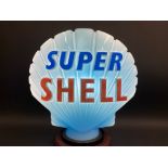 A blue Super Shell glass petrol pump globe by Hailware, in good condition, dated December 1973,