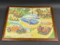 A framed and glazed motoring themed jigsaw puzzle depicting six different cars through the ages,