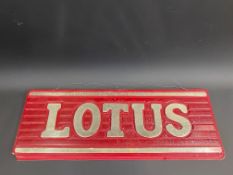 A Lotus ribbed plastic hanging showroom window sign, 24 1/4 x 9".