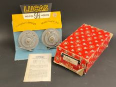 A pair of new old stock Lucas 12v Windtone horns, on a display card for the shop counter.