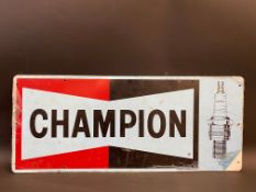A new old stock Champion spark plugs tin advertising sign, 23 x 9 1/2".