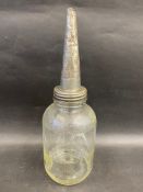 A Mobiloil 'A' grade American glass oil bottle with embossed conical lid.