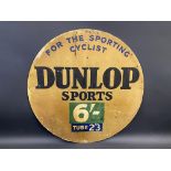 A Dunlop Sports 'For The Sporting Cyclist' circular cardboard advertising sign, 23 1/2" diameter.