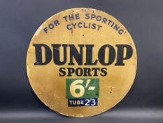 A Dunlop Sports 'For The Sporting Cyclist' circular cardboard advertising sign, 23 1/2" diameter.
