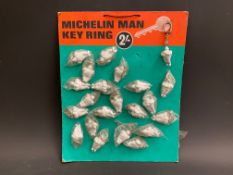 A rare surviving point of sale hanging display card, dispensing Michelin man keyrings.