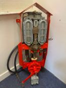 A Watts, Fincham & Co. wall mounted two gallon petrol pump, restored in Shell colours with hose