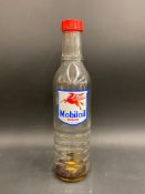 A Mobiloil glass quart oil bottle, unusually with the additional word 'Vacuum' to the label.
