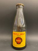 A Shell Triple Shell oil bottle.