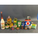 A selection of assorted grease and oil tins etc.