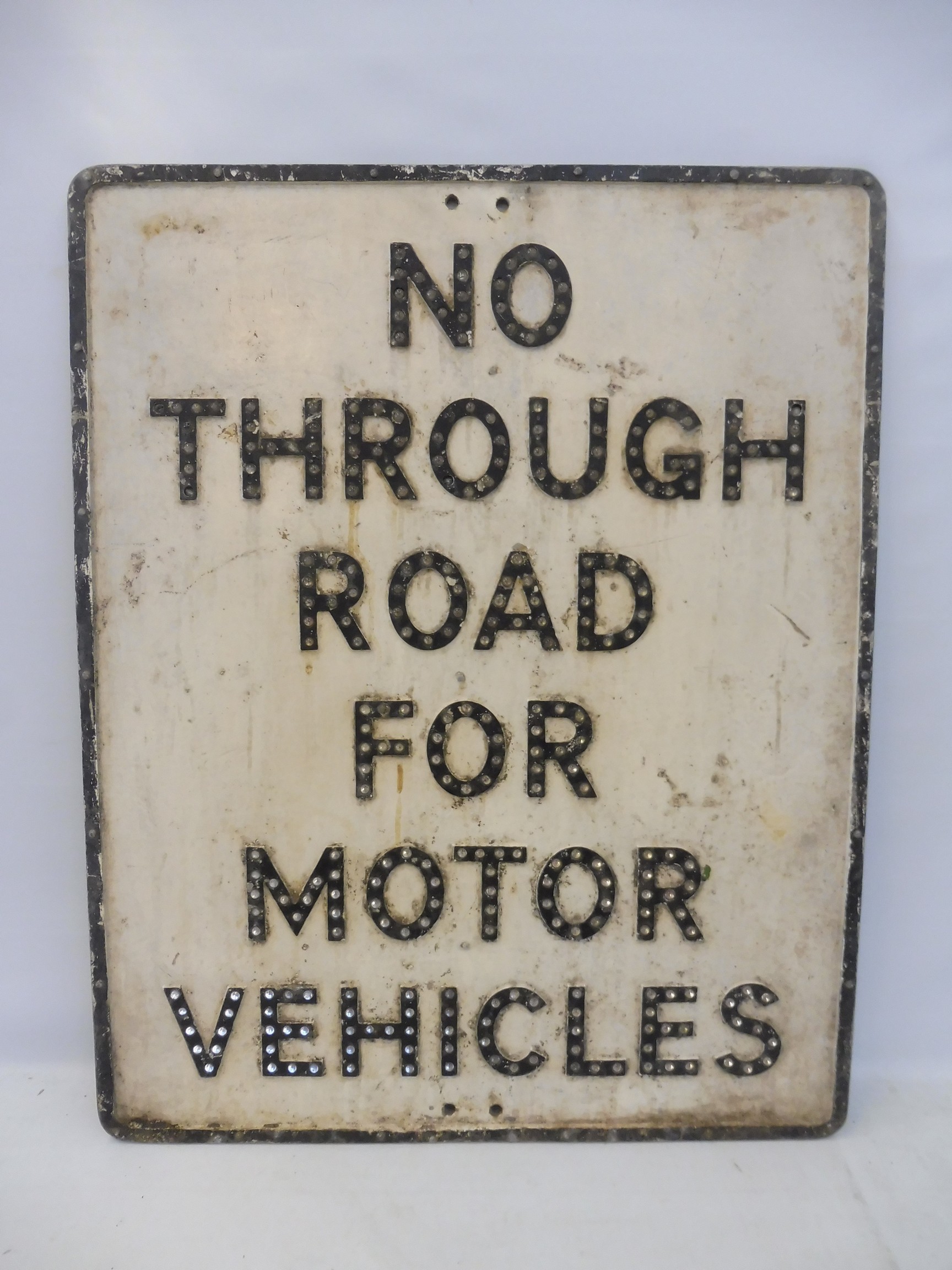 A 'No Through Road for Motor Vehicles' aluminium road sign with integral glass reflective beads,