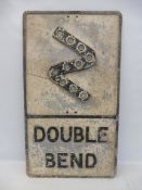 A large aluminium 'Double Bend' road sign, with integral reflective discs, 17 x 30".