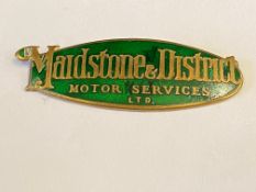 A Maidstone & District Motor Services Ltd brass and green enamel badge.