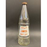 A Lobitos conical glass oil bottle with moulded lettering to one side and a good label to the other,