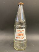 A Lobitos conical glass oil bottle with moulded lettering to one side and a good label to the other,