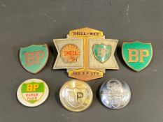 A Shell-Mex & BP Ltd cap badge, two BP enamelled lapel badges, a BP Super Plus badge and two BP