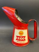 A Shell X-100 Motor Oil pint measure in excellent condition.
