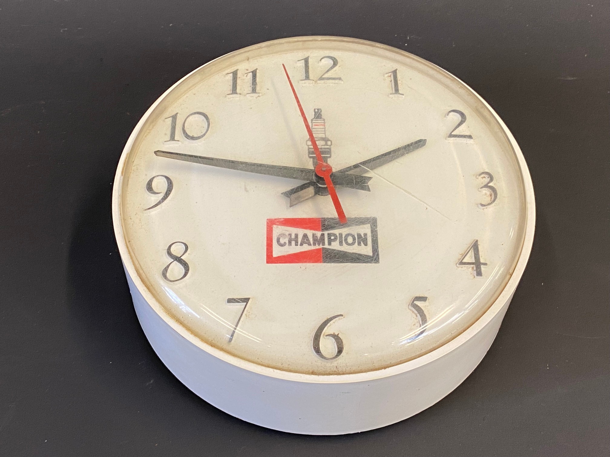 A Champion spark plugs circular dealership wall clock, 6 1/2" diameter.