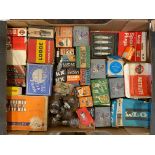A box of lamp bulb packaging and spark plug boxes, some with contents.