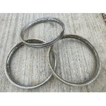 Three motorcycle rims, two appear to have been rechromed.