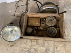 A box of assorted motorcycle parts including two Lucas headlamps, horns, and