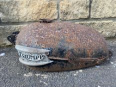 A Triumph petrol tank still with badges attached.