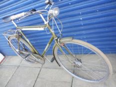 A Triumph gentleman's bicycle complete with bell and dynamo headlight.