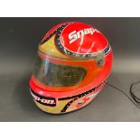A radio in the shape of a motorcycle helmet with Snap On advertising.