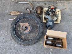 A group of assorted motorcycle parts including shock absorbers, wheel etc.