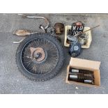 A group of assorted motorcycle parts including shock absorbers, wheel etc.