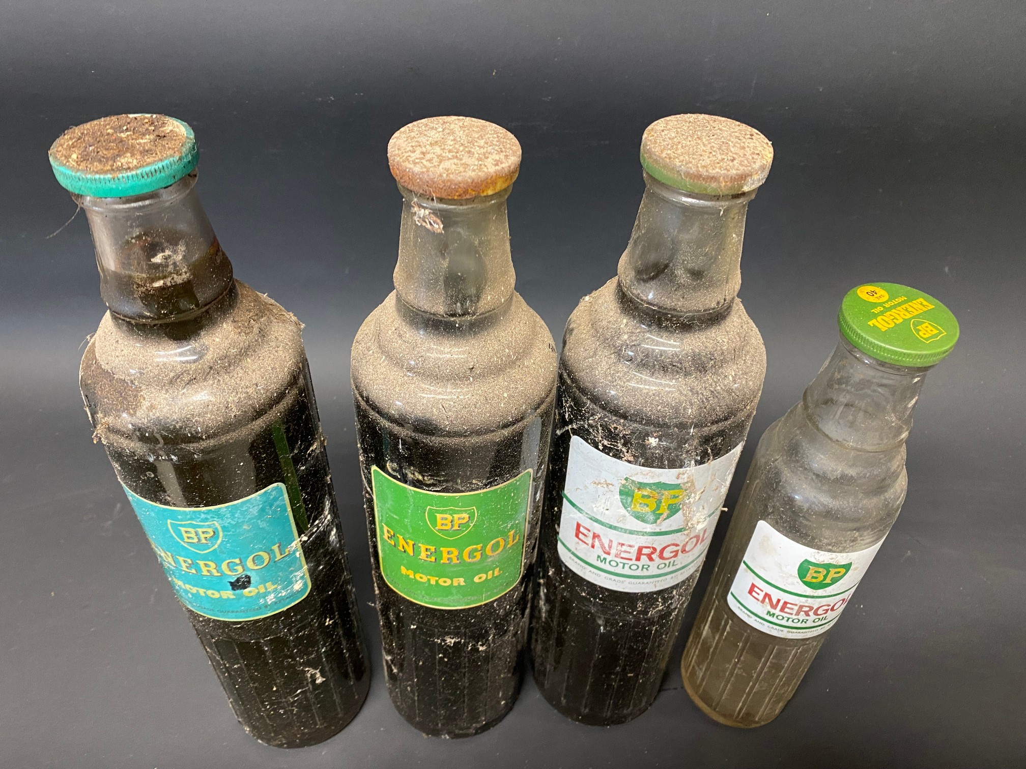 Three BP Energol quart oil bottles and a pint version.