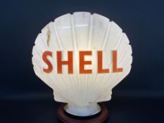 A Shell glass petrol pump globe by Hailware, dated August 1972.