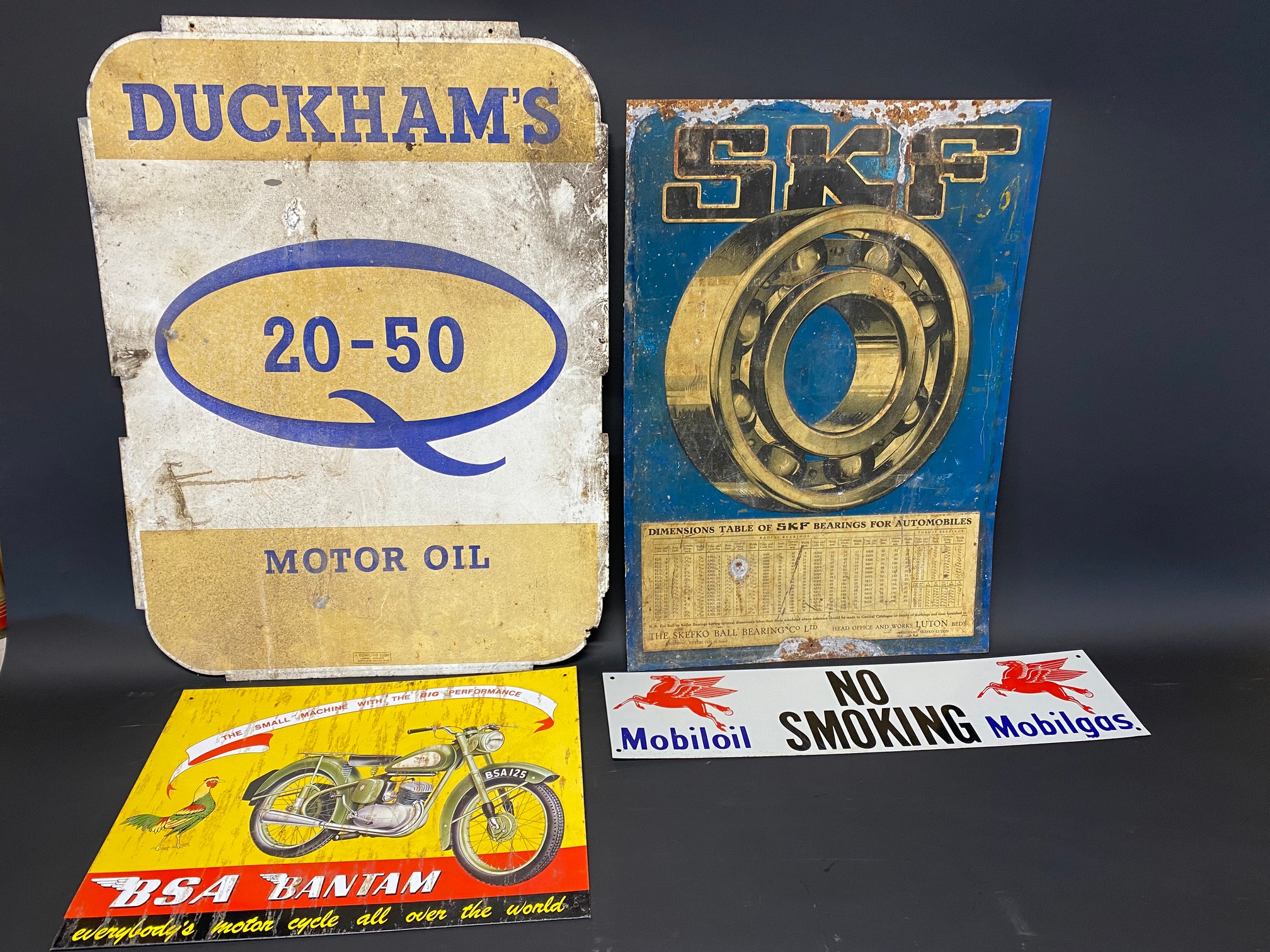 A Duckham's 20-50 Motor Oil double sided tin advertising sign, 18 x 24", a tin advertising sign