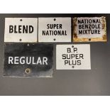 Five small enamel petrol pump brand indicator signs including BP Super Plus.