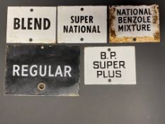 Five small enamel petrol pump brand indicator signs including BP Super Plus.