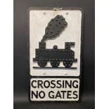 An aluminium road sign for Crossing No Gates depicting a steam locomotive, with integral glass