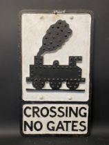 An aluminium road sign for Crossing No Gates depicting a steam locomotive, with integral glass