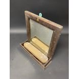 An AA wall hanging mirror with brush compartment.