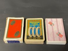 A quantity of Dominion Tyres playing cards, a pack of Dunlop playing cards and a third for Regent