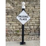 A lozenge shaped road sign for Passing Place, post mounted.